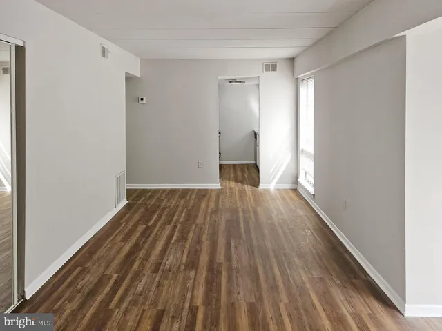 a view of a room with wooden floor