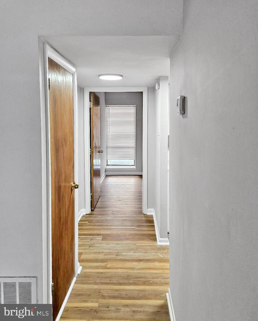 233 Township Line Road, Unit 2A Elkins Park, PA 19027 - Photo 10 of 24 a view of a hallway with wooden floor and staircase