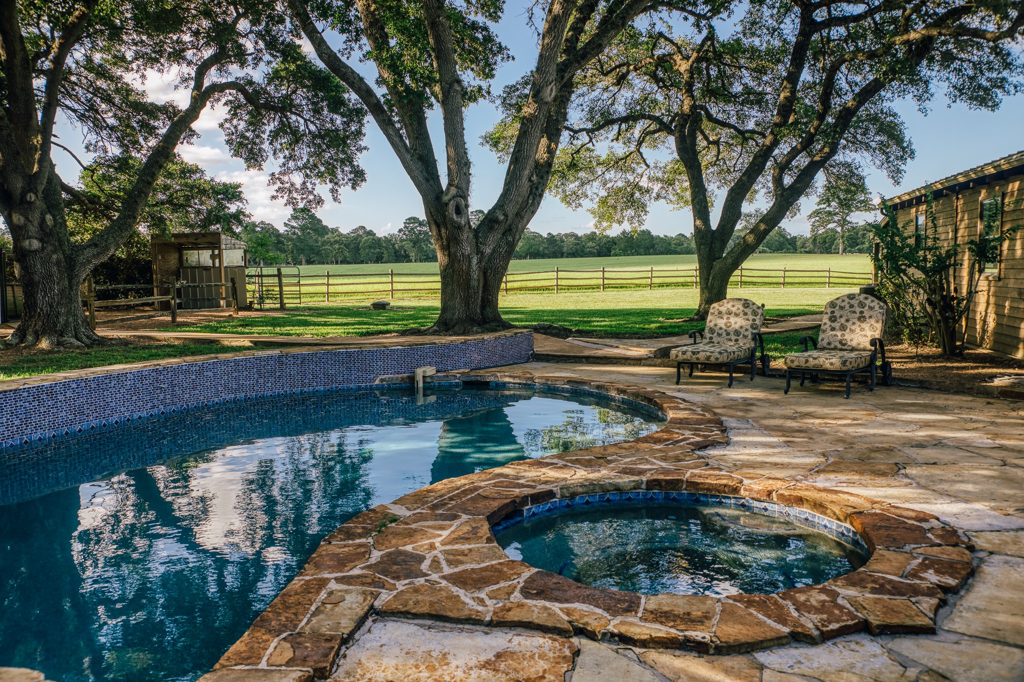 1034 Hilbun Road New Ulm, TX 78950 - Photo 27 of 49 Rich in character and warmth, the main home features spacious living and dining areas, a chef’s kitchen, stone fireplace, pool and spa, outdoor entertaining spaces, and scenic views of the surrounding countryside