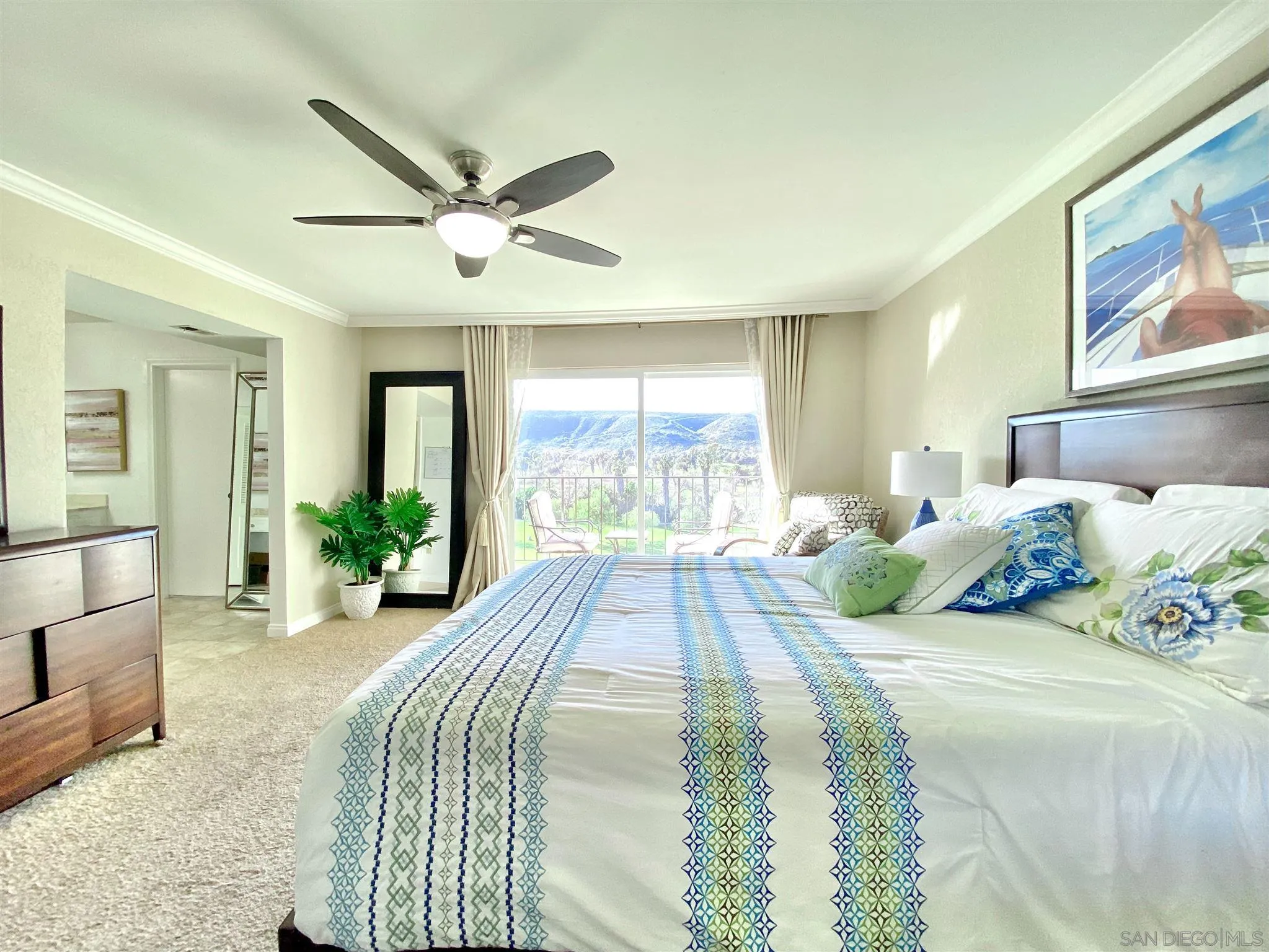 6780 Mission Gorge Road, Unit 30 San Diego, CA 92120 - Photo 12 of 24 a spacious bedroom with a bed and large windows
