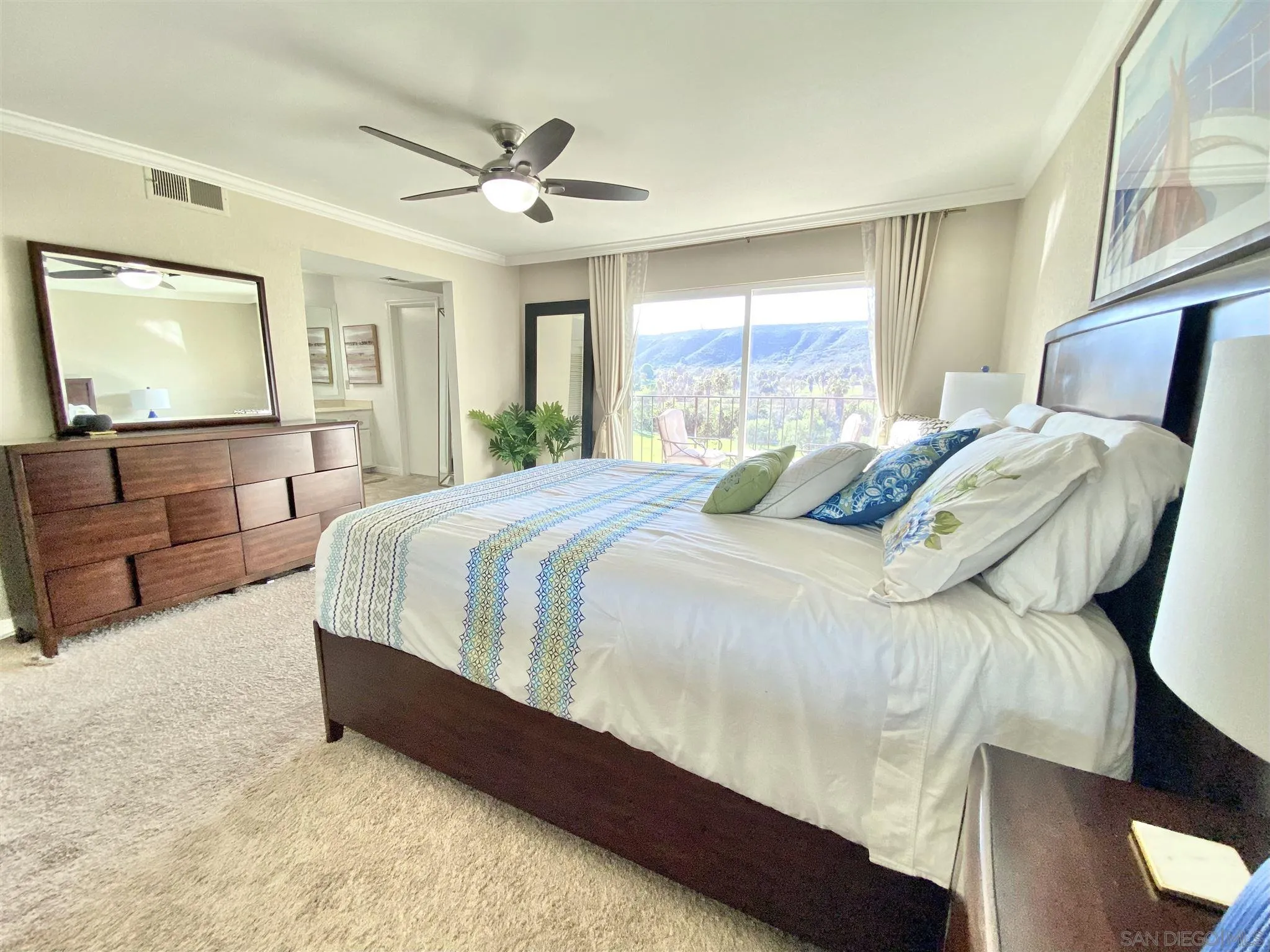 6780 Mission Gorge Road, Unit 30 San Diego, CA 92120 - Photo 14 of 24 a bedroom with bed and window with couch