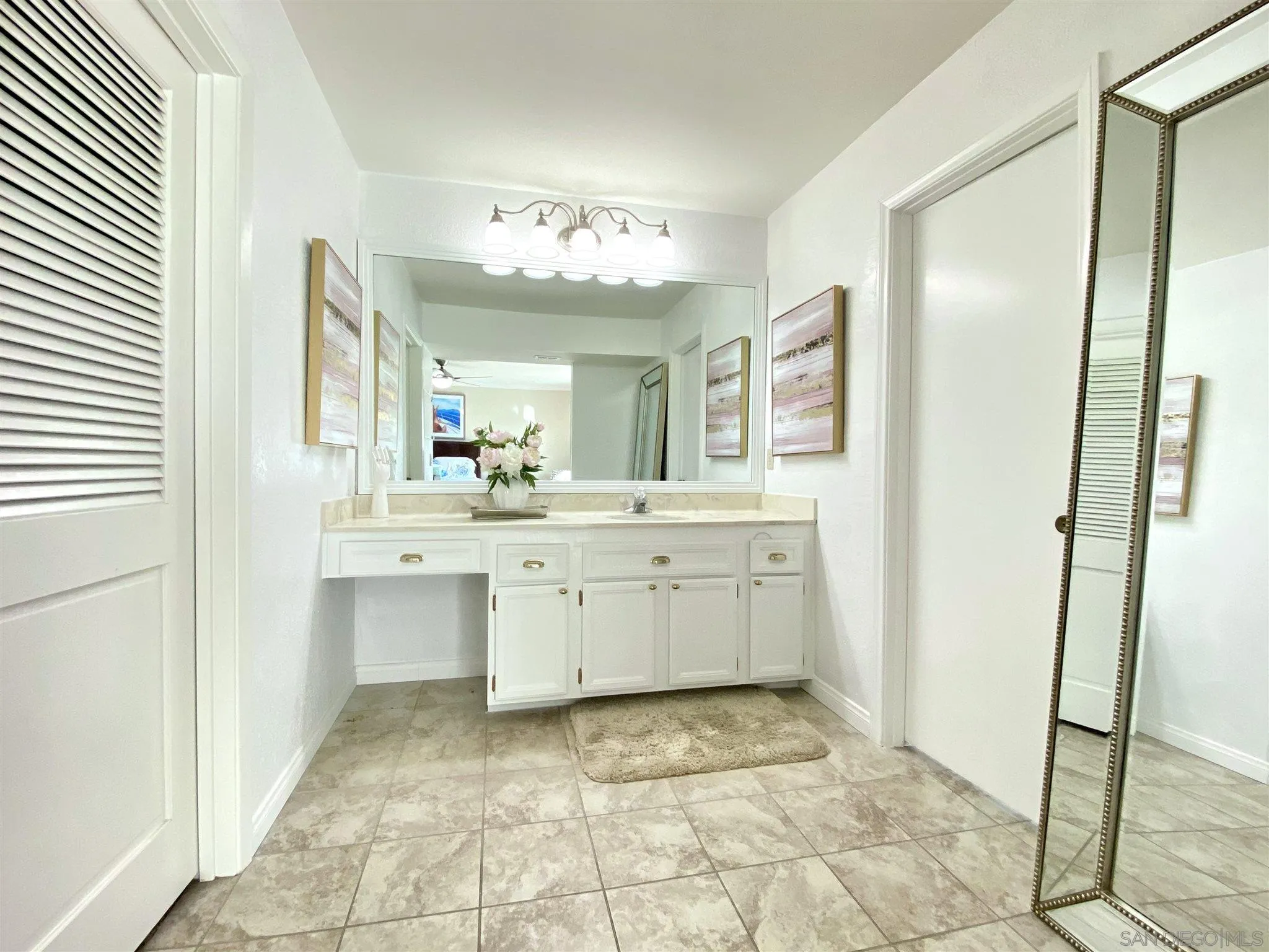 6780 Mission Gorge Road, Unit 30 San Diego, CA 92120 - Photo 16 of 24 a bathroom with a sink a mirror and a vanity