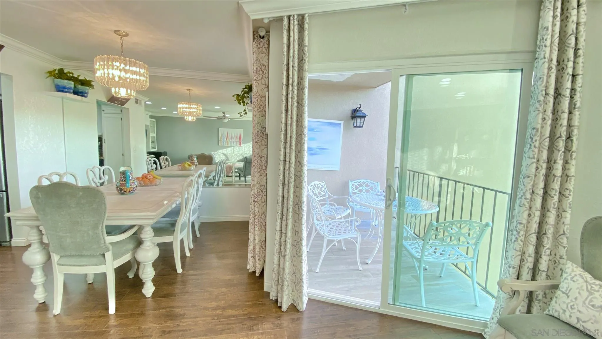 6780 Mission Gorge Road, Unit 30 San Diego, CA 92120 - Photo 2 of 24 a dining room with furniture a chandelier and wooden floor