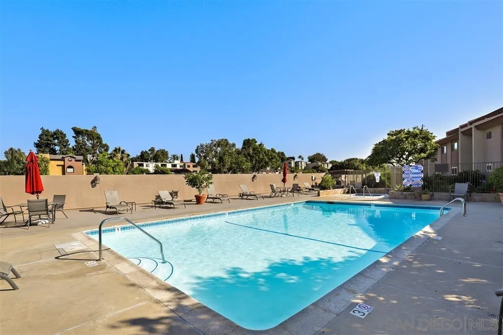 6780 Mission Gorge Road, Unit 30 San Diego, CA 92120 - Photo 21 of 24 a view of a swimming pool with an outdoor seating and a many windows