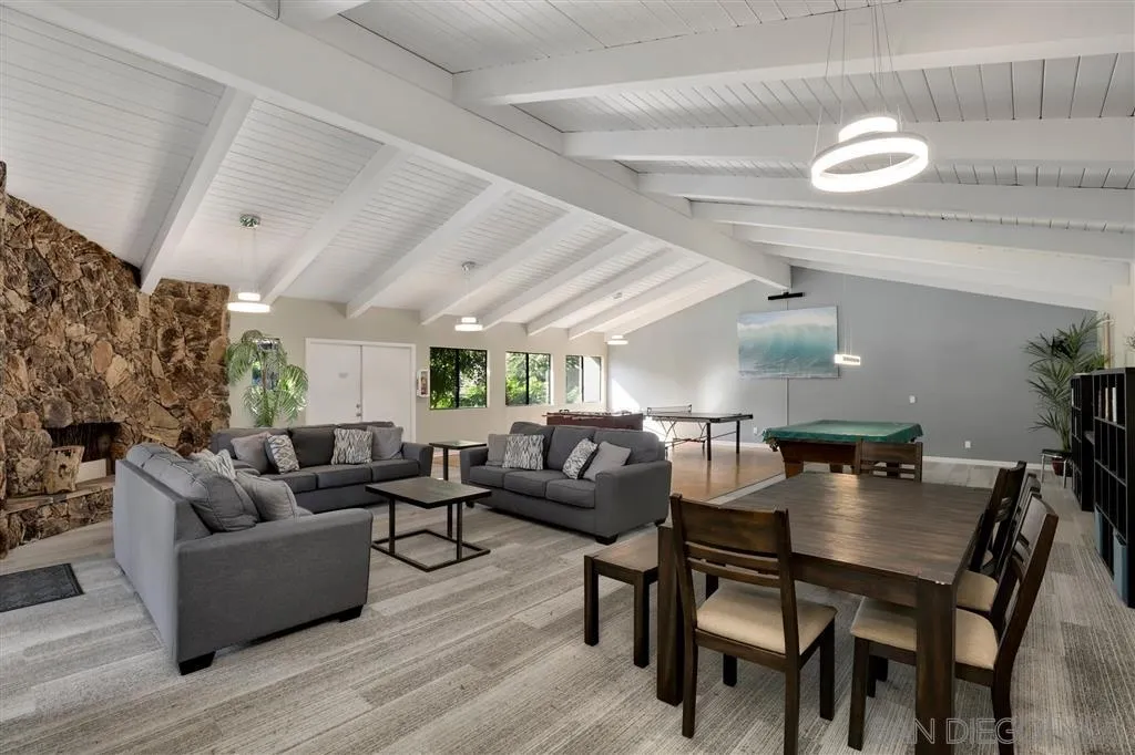 6780 Mission Gorge Road, Unit 30 San Diego, CA 92120 - Photo 22 of 24 a living room with furniture a chandelier and a wooden floor