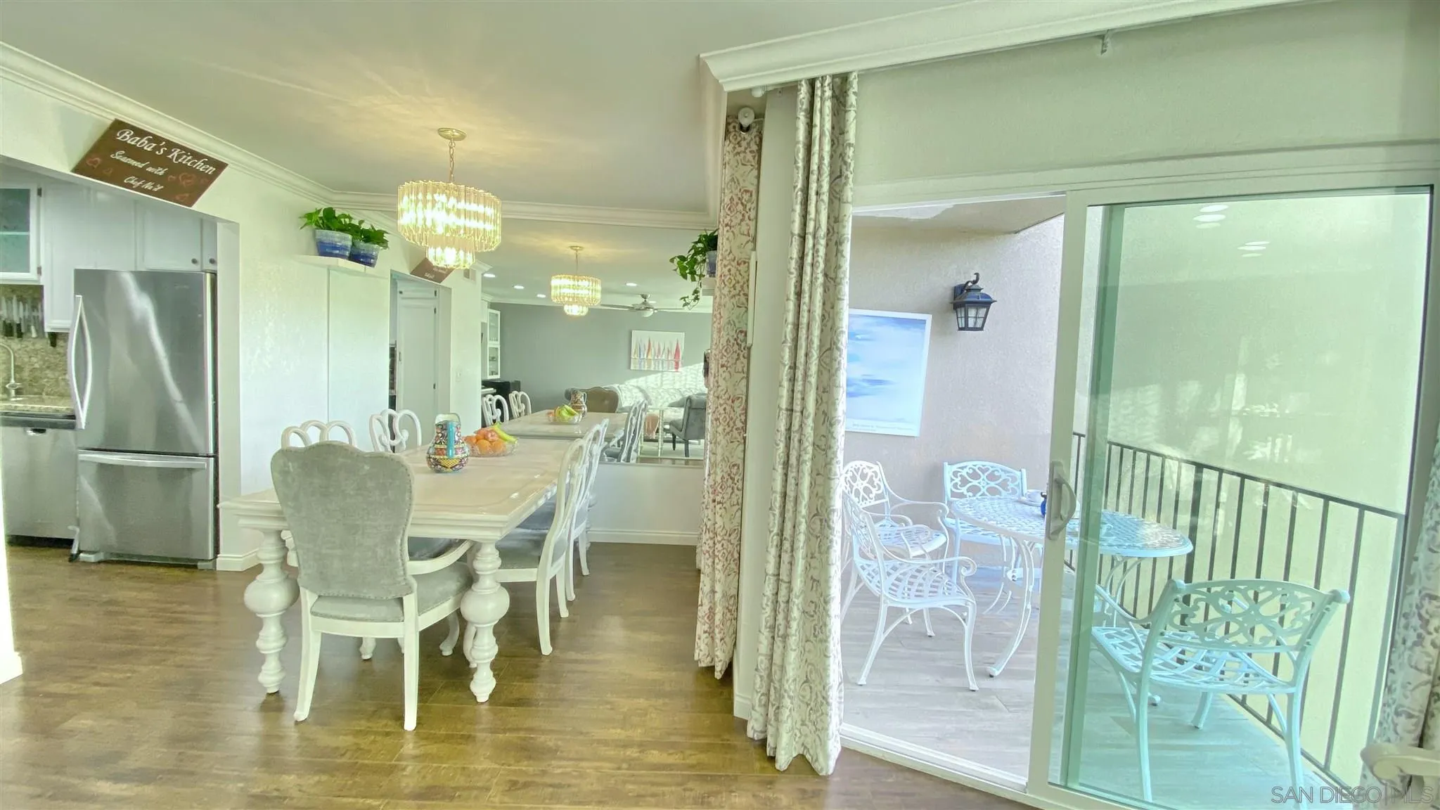 6780 Mission Gorge Road, Unit 30 San Diego, CA 92120 - Photo 3 of 24 a dining room with furniture a chandelier and wooden floor