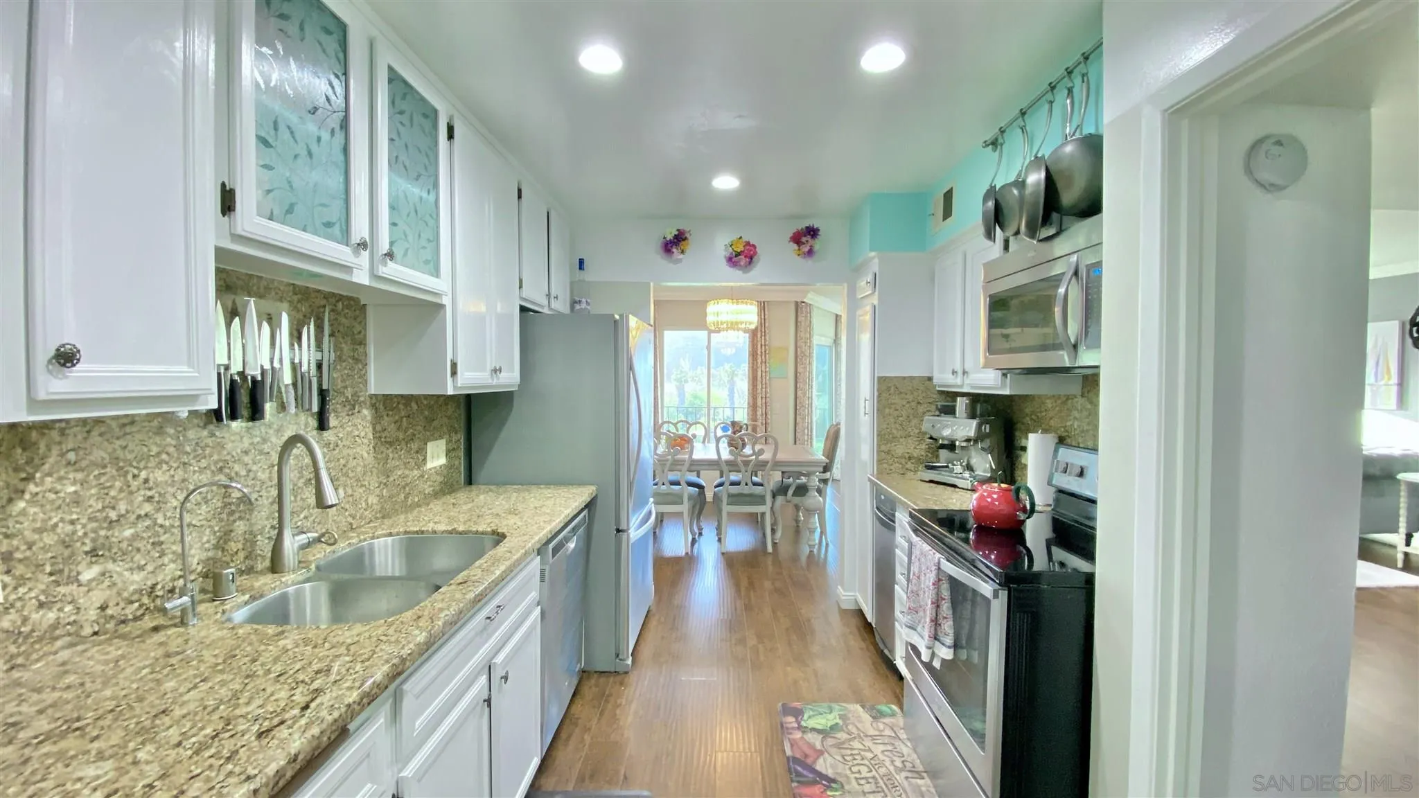 6780 Mission Gorge Road, Unit 30 San Diego, CA 92120 - Photo 4 of 24 a kitchen with sink cabinets and outdoor view