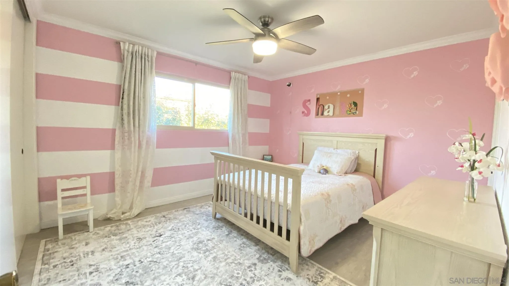 6780 Mission Gorge Road, Unit 30 San Diego, CA 92120 - Photo 9 of 24 a bedroom with a bed and a chandelier