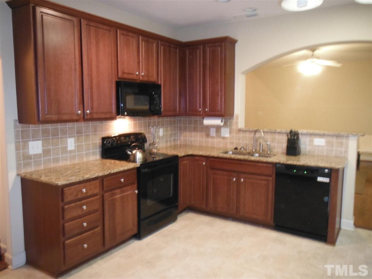3924 Landing Brook Lane Raleigh, NC 27616 - Photo 12 of 23 Granite Counters, Black Appliances, backsplash, Beautiful Wood Cabinets with accent crown molding. Plenty of workspace! Just off Kitchen- between the dining room is a huge pantry closet.