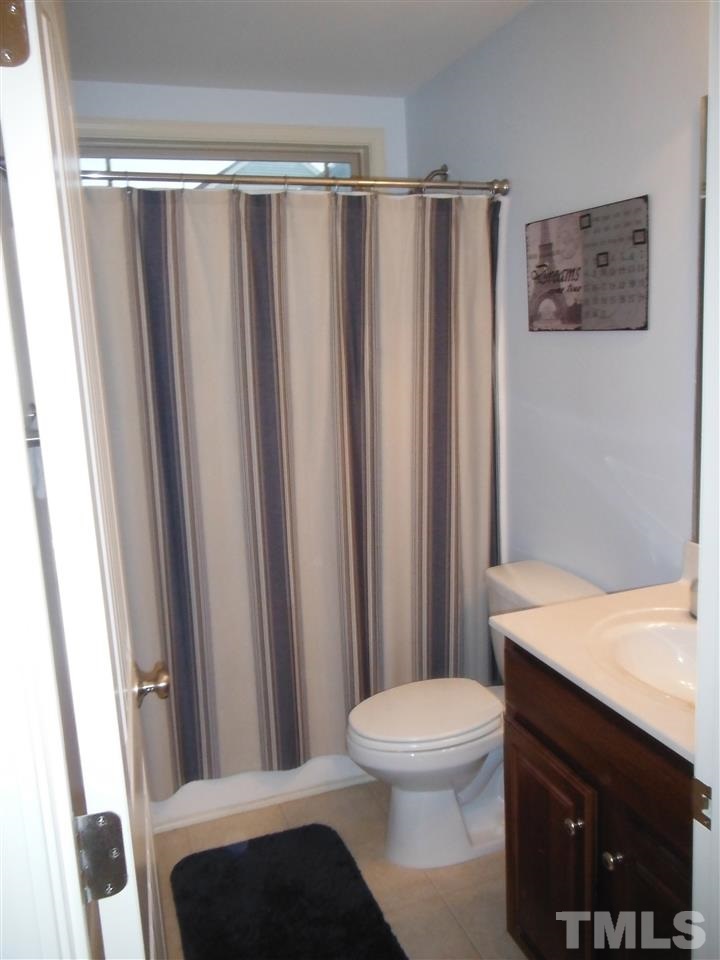 3924 Landing Brook Lane Raleigh, NC 27616 - Photo 15 of 23 Full Bath in 2nd Floor Hall. Dark Wood Cabinets, Shower/Tub & window allowing natural light