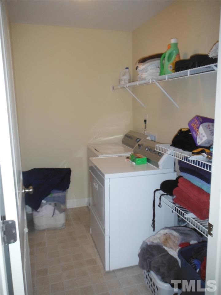 3924 Landing Brook Lane Raleigh, NC 27616 - Photo 17 of 23 Washer & Dryer room has tons of storage shelves on 2nd floor.