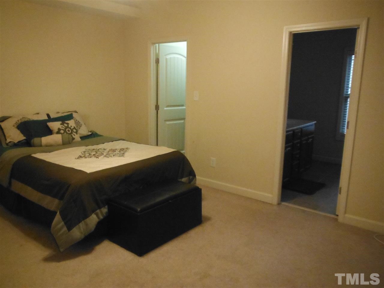 3924 Landing Brook Lane Raleigh, NC 27616 - Photo 20 of 23 Master Bedroom on 2nd floor is spacious, 3 windows overlooking the wooded area behind the home. Walk In Closet and Master Bath with Separate Tub & Shower. Decorative Shelf accents the vaulted ceiling.