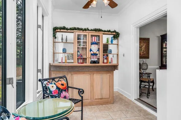 a storage room with stainless steel appliances wooden floor and a chandelier