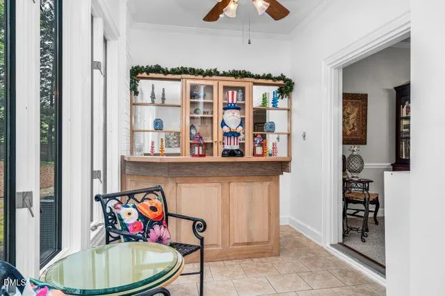 a storage room with stainless steel appliances wooden floor and a chandelier