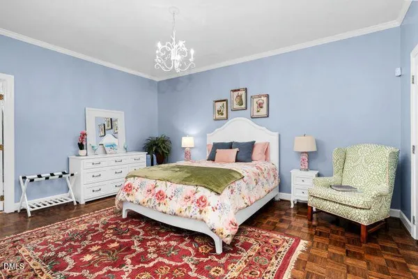 a bedroom with a bed and a chandelier