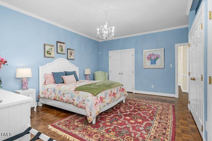 1311 Forest Hills Road Northwest, Unit D2 Wilson, NC 27896 - Photo 23 of 31 a bedroom with a bed and a chandelier