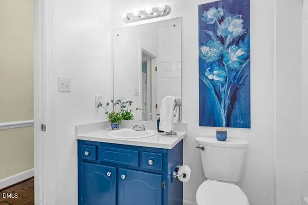 a bathroom with a toilet a sink and a mirror