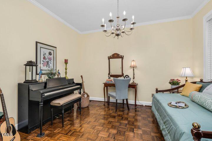 1311 Forest Hills Road Northwest, Unit D2 Wilson, NC 27896 - Photo 6 of 31 a living room with furniture a piano and a chandelier