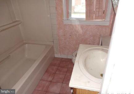 3496 Dunhaven Road Baltimore, MD 21222 - Photo 6 of 10 a bathroom with a tub and a sink