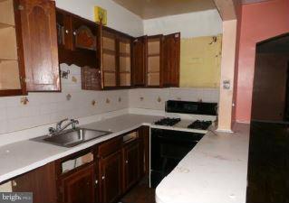 3496 Dunhaven Road Baltimore, MD 21222 - Photo 7 of 10 a kitchen with a sink and a refrigerator