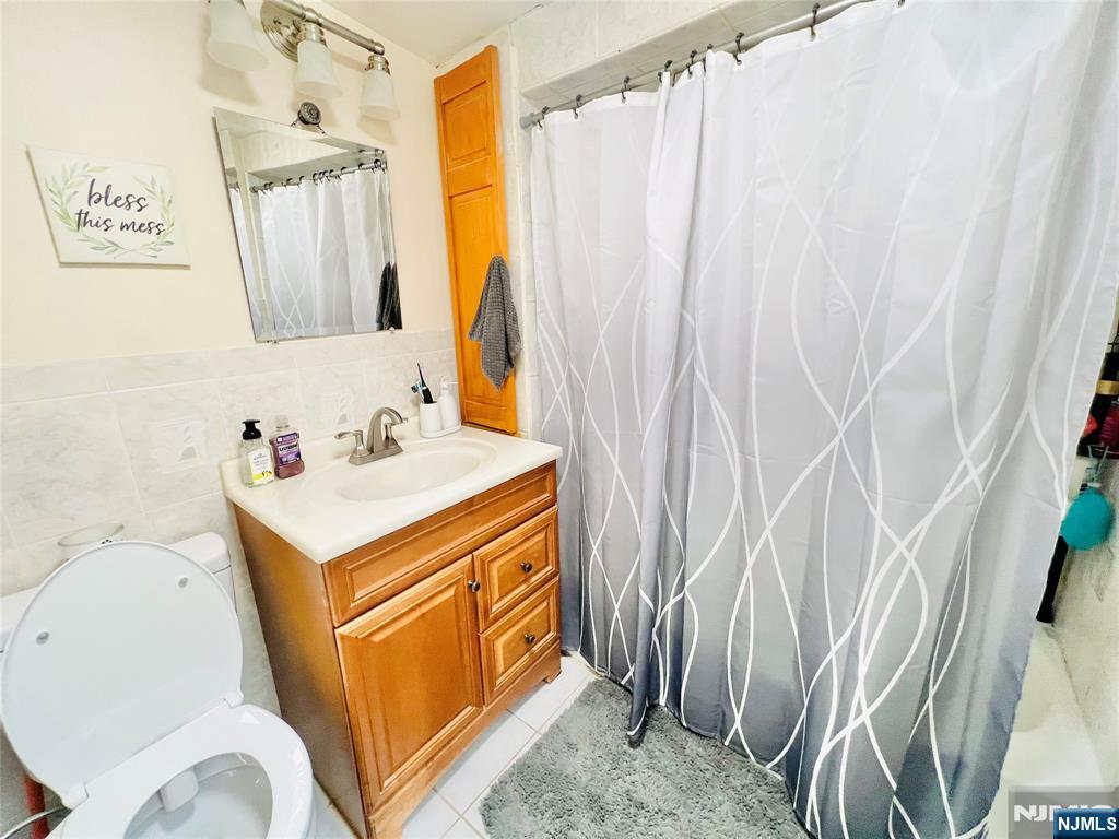 155 Ford Street Wayne, NJ 07470 - Photo 13 of 14 a bathroom with a sink a toilet and a mirror