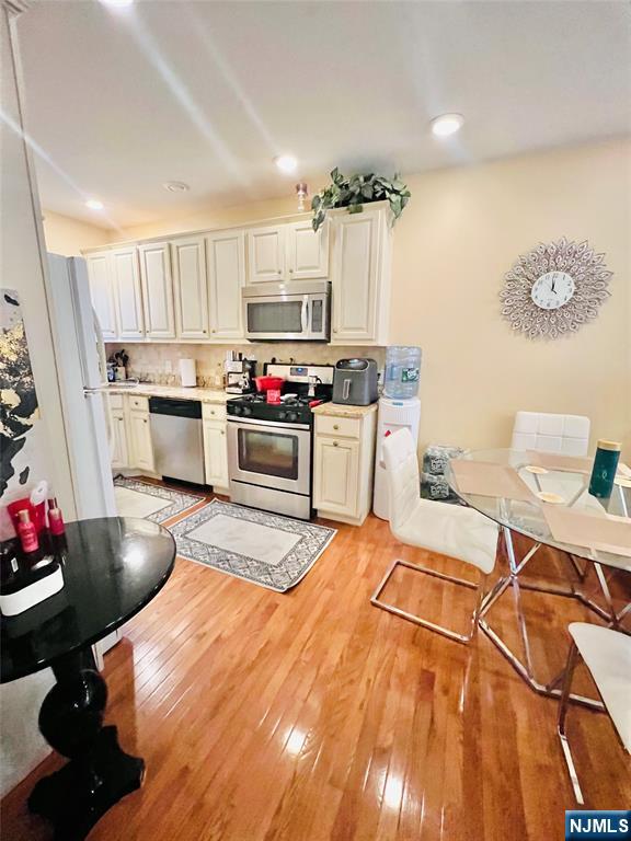 155 Ford Street Wayne, NJ 07470 - Photo 2 of 14 a kitchen with stainless steel appliances a stove a sink cabinets and wooden floor