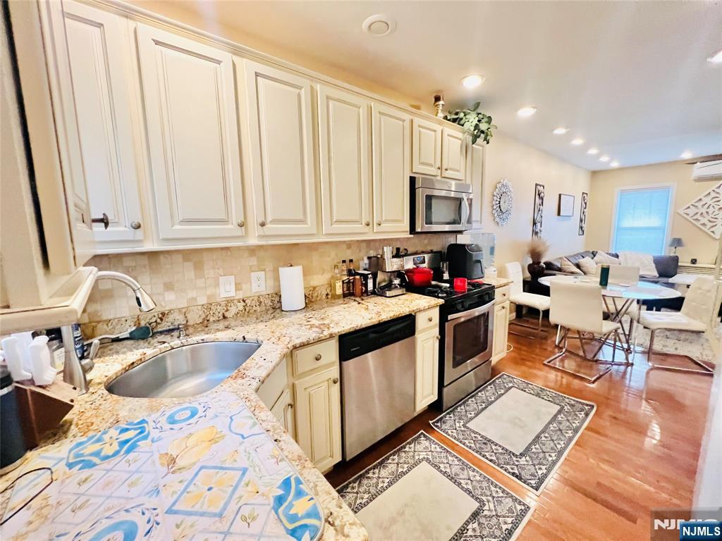 155 Ford Street Wayne, NJ 07470 - Photo 5 of 14 a kitchen with stainless steel appliances granite countertop a sink stove and cabinets