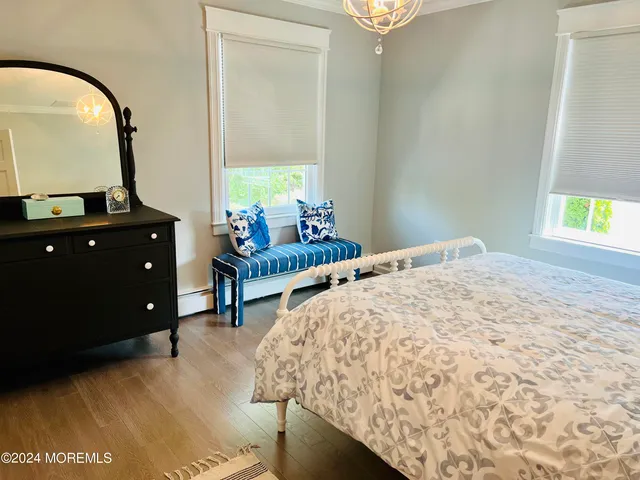 a bedroom with a bed window and a table