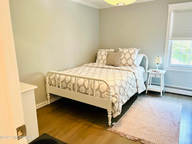 a bed sitting in a bedroom next to a window