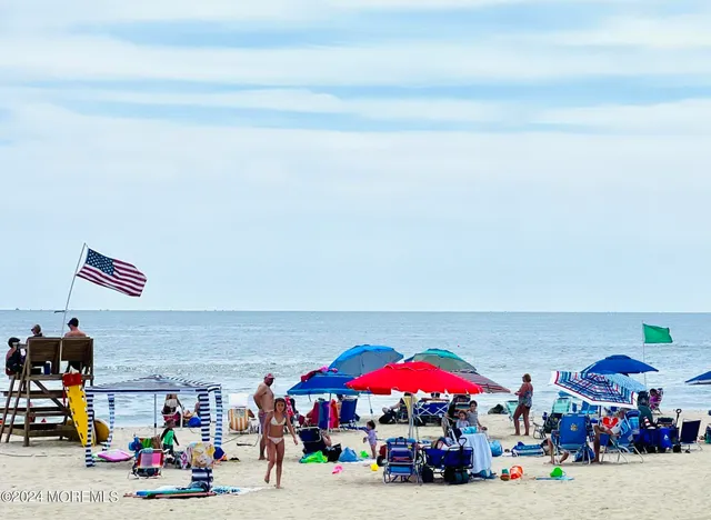 a patio with a table and chairs under an umbrella
