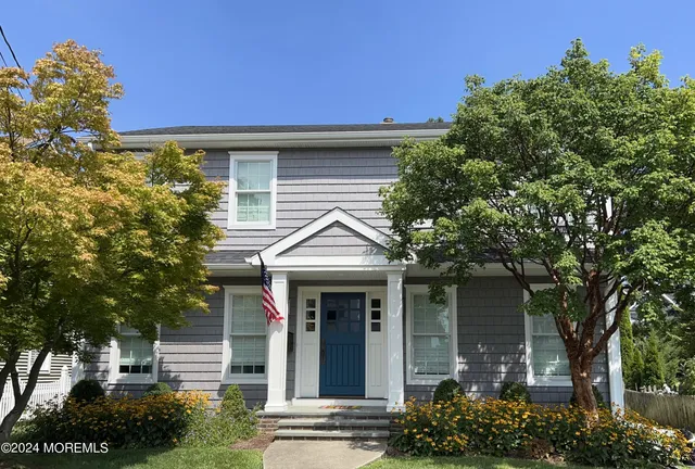 front view of a house with a tree