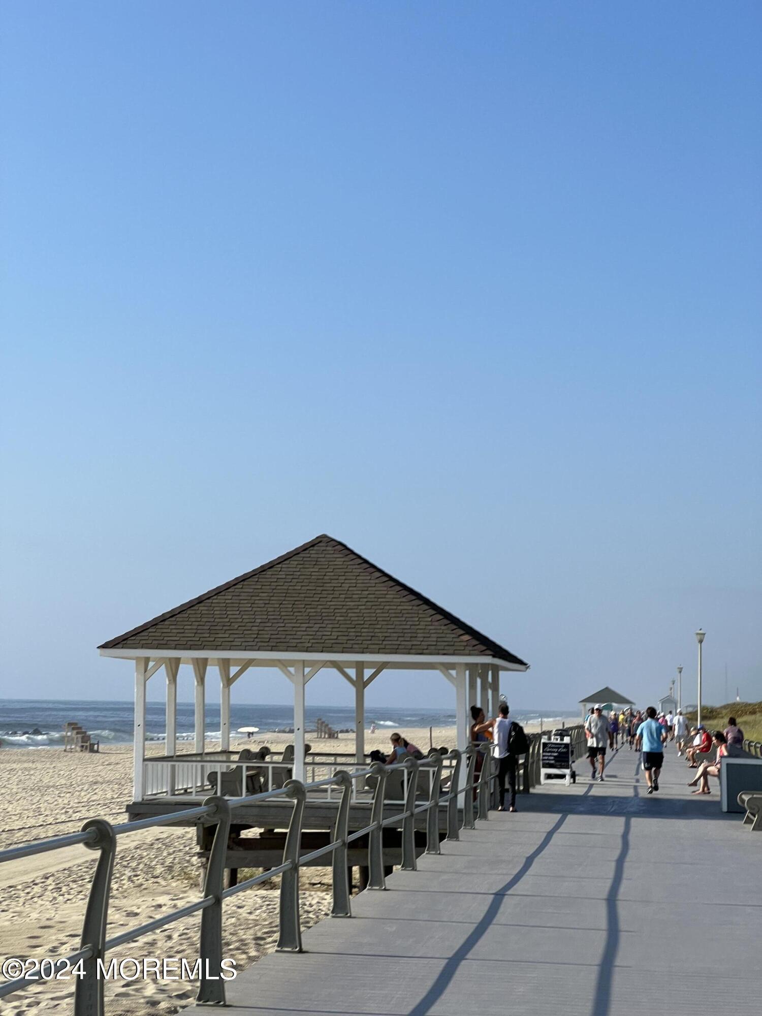 2122 Edgewood Place Spring Lake, NJ 07762 - Photo 21 of 23 a patio with a table and chairs under an umbrella