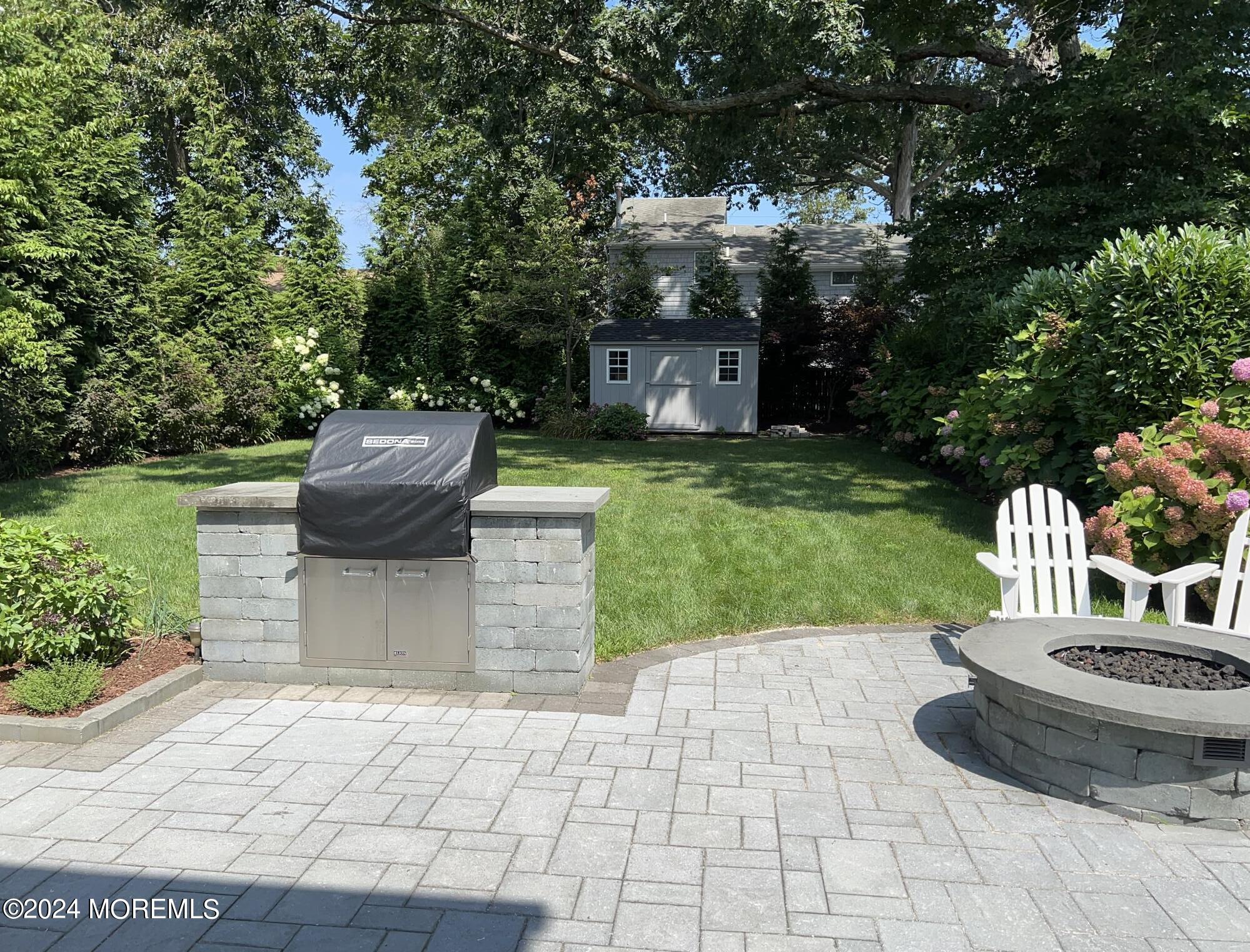 2122 Edgewood Place Spring Lake, NJ 07762 - Photo 6 of 23 a view of a garden with a fountain