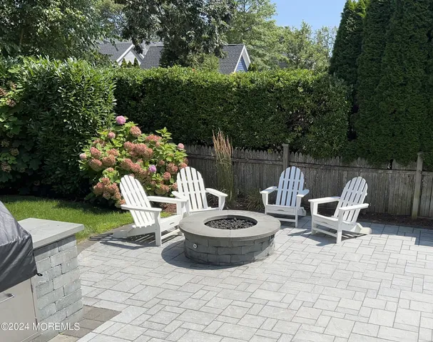 a view of a backyard with furniture and garden