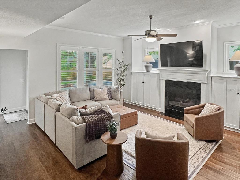 12912 Southwest 3rd Place Newberry, FL 32669 - Photo 14 of 38 a living room with furniture a fireplace and a flat screen tv