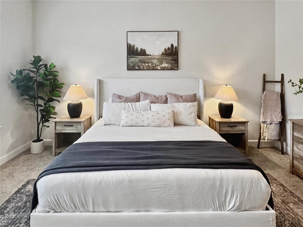 12912 Southwest 3rd Place Newberry, FL 32669 - Photo 15 of 38 a bedroom with a large bed and a potted plant