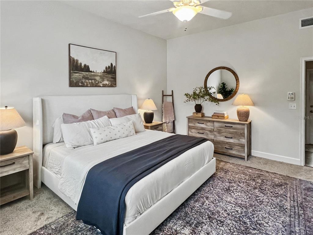 12912 Southwest 3rd Place Newberry, FL 32669 - Photo 16 of 38 a bedroom with bed and a chandelier