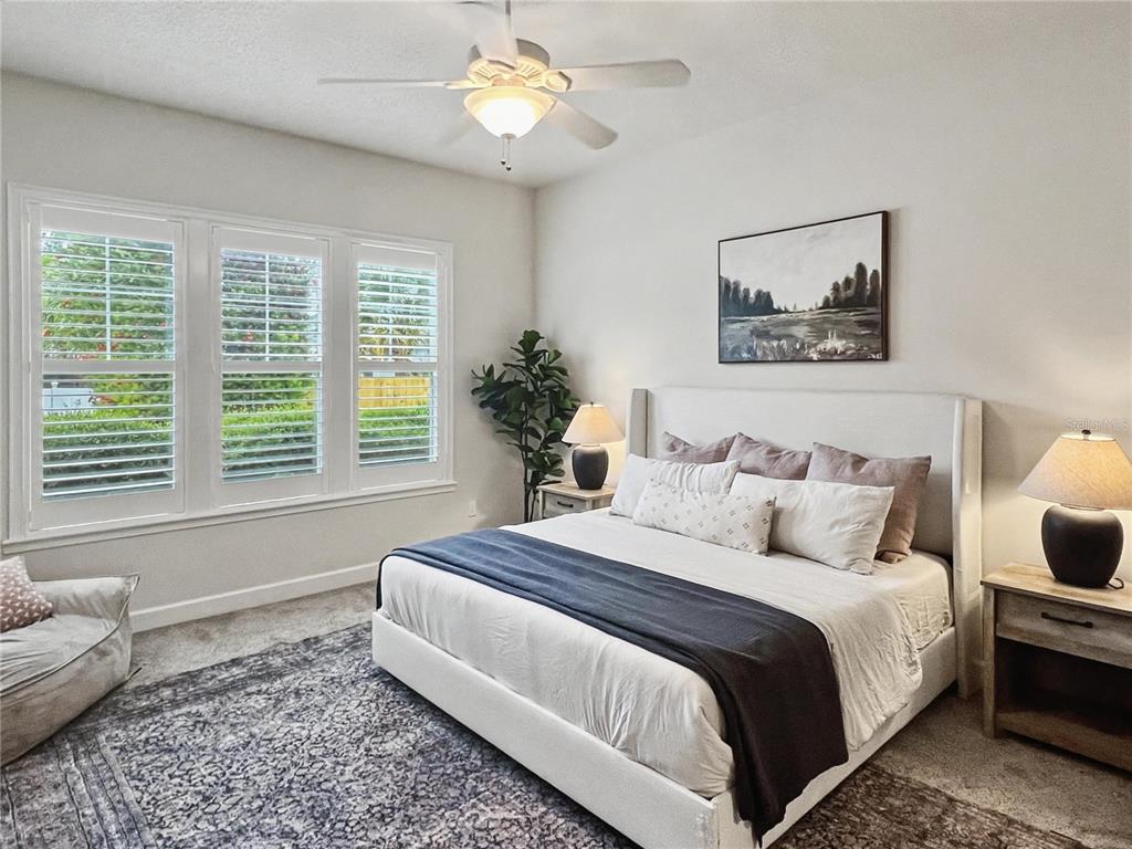 12912 Southwest 3rd Place Newberry, FL 32669 - Photo 17 of 38 a spacious bedroom with a bed and a window