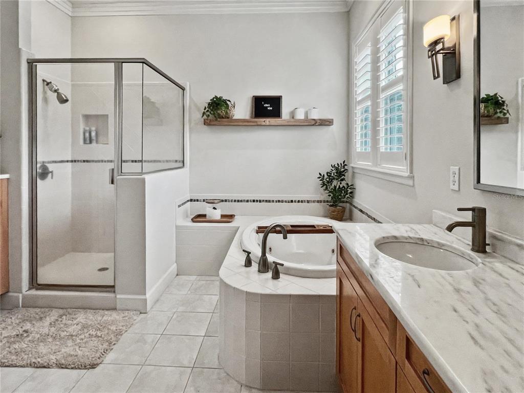 12912 Southwest 3rd Place Newberry, FL 32669 - Photo 18 of 38 a bathroom with a granite countertop sink a mirror and shower