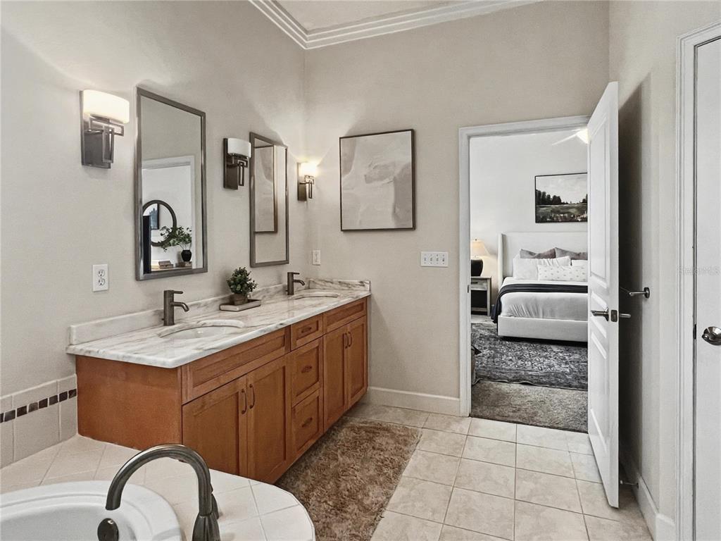 12912 Southwest 3rd Place Newberry, FL 32669 - Photo 19 of 38 a en suite bathroom with a granite countertop sink and a mirror