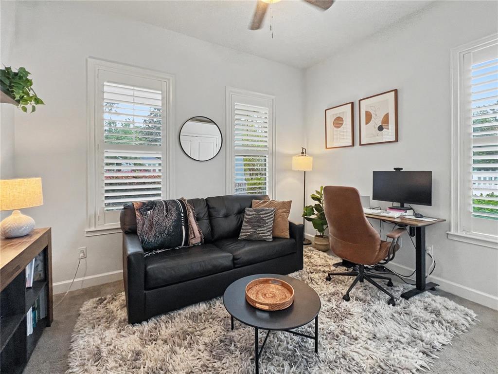12912 Southwest 3rd Place Newberry, FL 32669 - Photo 24 of 38 a living room with furniture a flat screen tv and a window