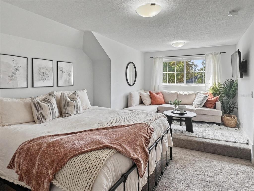 12912 Southwest 3rd Place Newberry, FL 32669 - Photo 26 of 38 a bedroom with a large bed and a couch