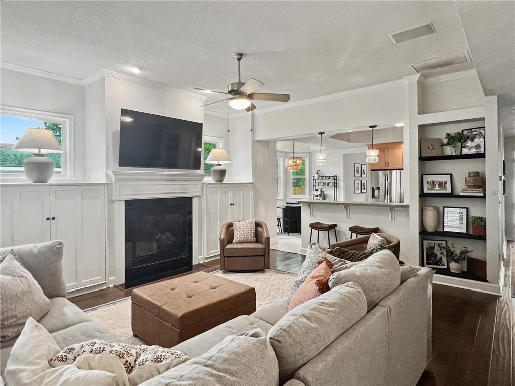 12912 Southwest 3rd Place Newberry, FL 32669 - Photo 3 of 38 a living room with furniture a fireplace and a flat screen tv