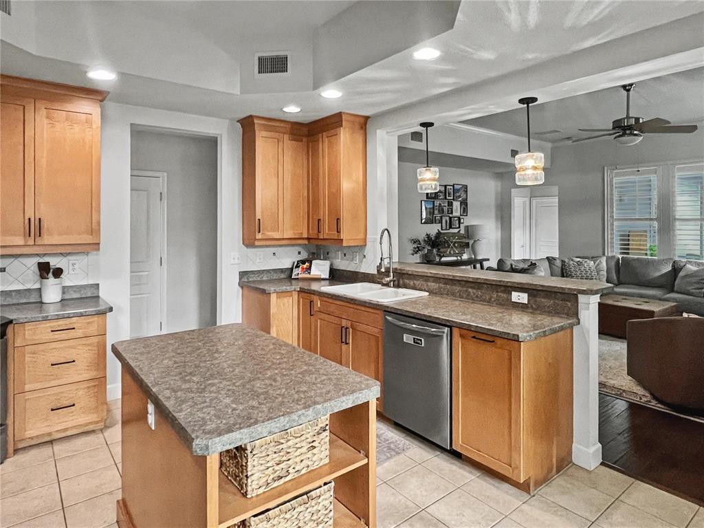 12912 Southwest 3rd Place Newberry, FL 32669 - Photo 10 of 38 a kitchen with kitchen island granite countertop a sink counter top space appliances and cabinets