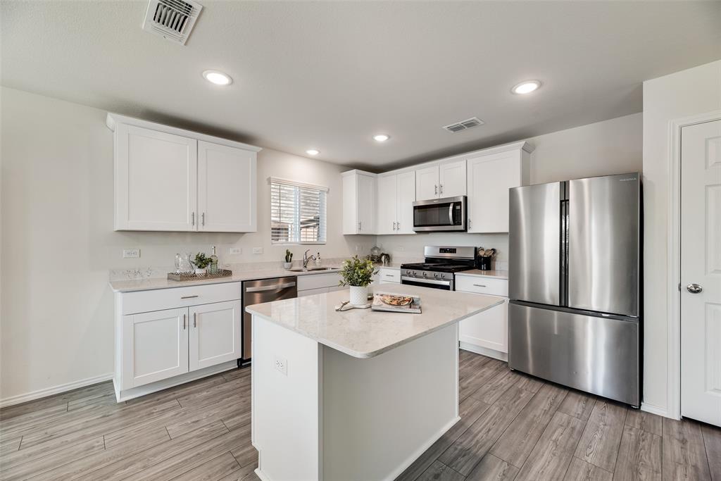 7005 Adderly Road Pilot Point, TX 76258 - Photo 9 of 38 Beautiful L-shaped kitchen complete with gas stove and stainless steel appliances