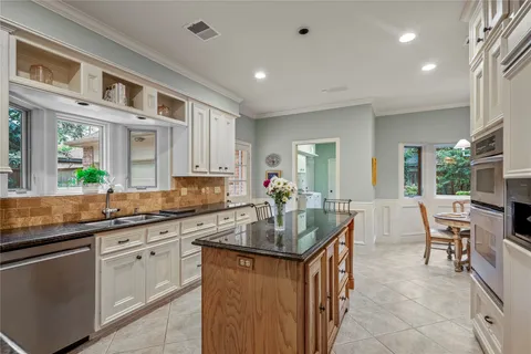 a kitchen with granite countertop a sink and cabinets
