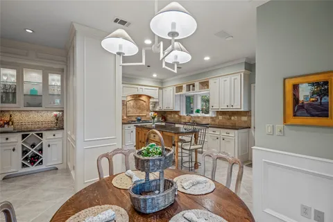 a kitchen with a table and chairs