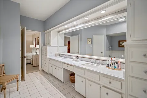 a spacious bathroom with a double vanity sink and a mirror