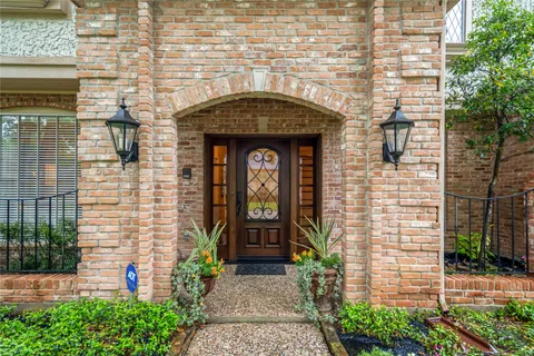 a front view of a house with potted plants