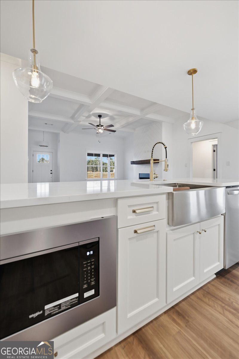 514 New Hope Drive Perry, GA 31069 - Photo 11 of 37 a kitchen with white cabinets and fireplace